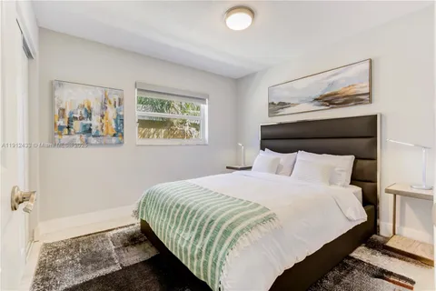 a bedroom with a bed and wall painting