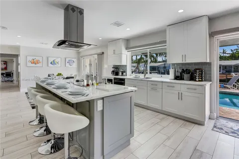 a kitchen with stainless steel appliances a sink stove and cabinets