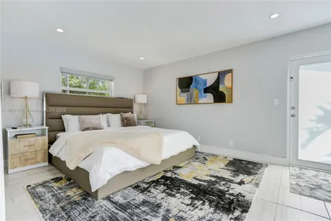 a bedroom with a bed and a painting on the wall