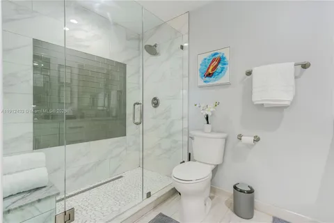 a bathroom with a toilet and a shower
