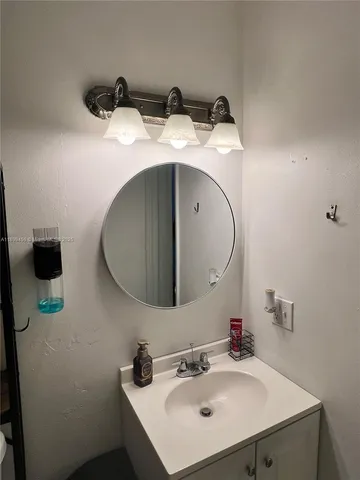 a bathroom with a sink and mirror