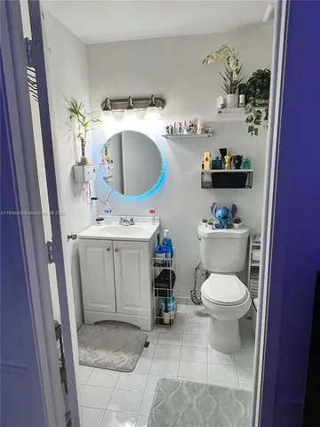 a bathroom with a sink toilet and mirror