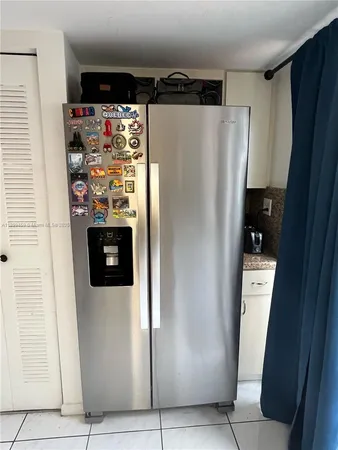 a refrigerator freezer sitting inside of a kitchen