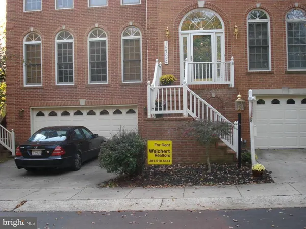 a front view of a house with parking space