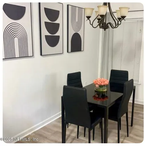 a dining room with furniture and wooden floor