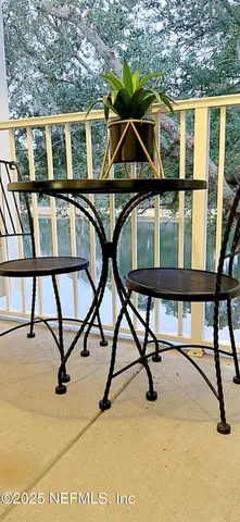 a view of a swimming pool with table and chairs