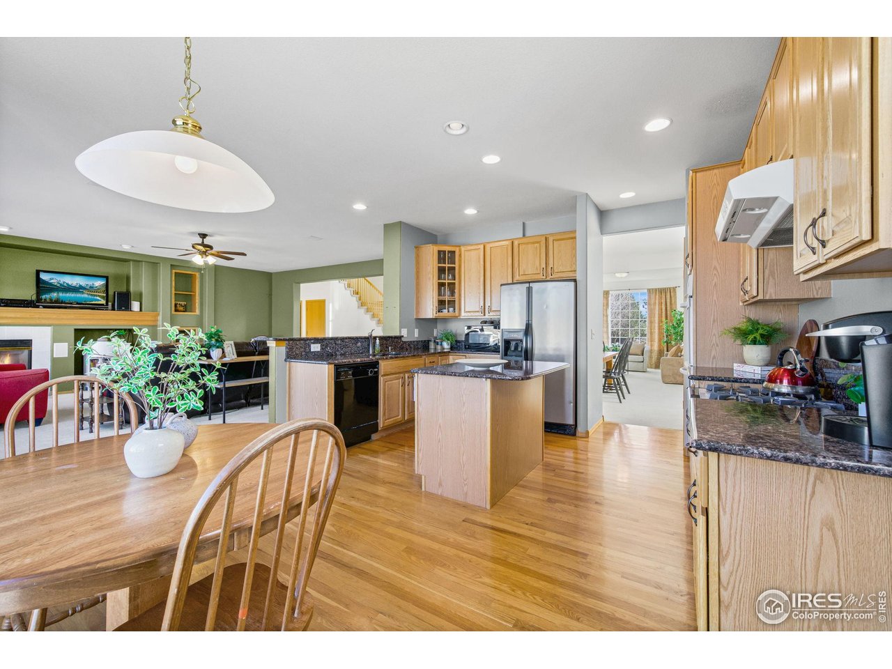 7133 Ranger Drive Fort Collins, CO 80526 - Photo 13 of 33 a view of a dining room and livingroom with furniture wooden floor a chandelier