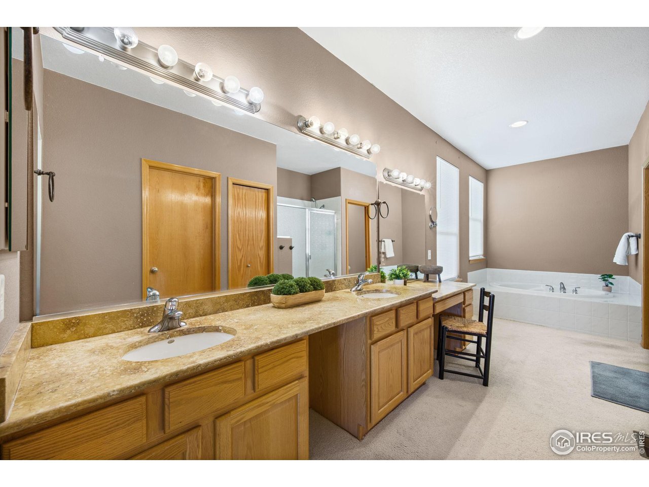 7133 Ranger Drive Fort Collins, CO 80526 - Photo 17 of 33 a bathroom with a double vanity sink and a mirror