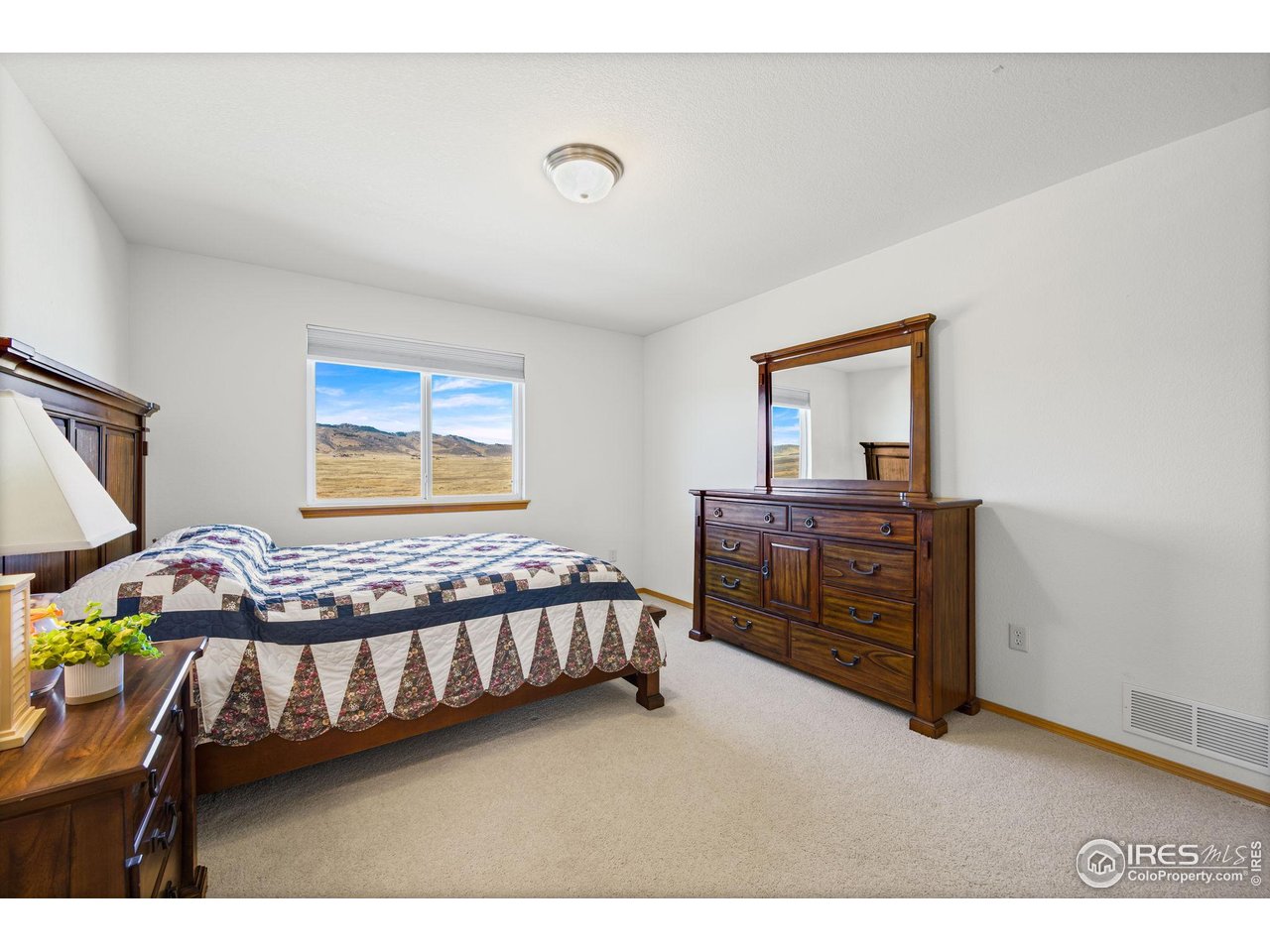 7133 Ranger Drive Fort Collins, CO 80526 - Photo 21 of 33 a bedroom with a bed window and dresser