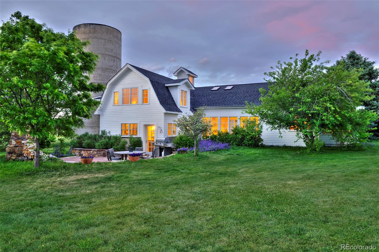 a front view of house with yard and trees in the background