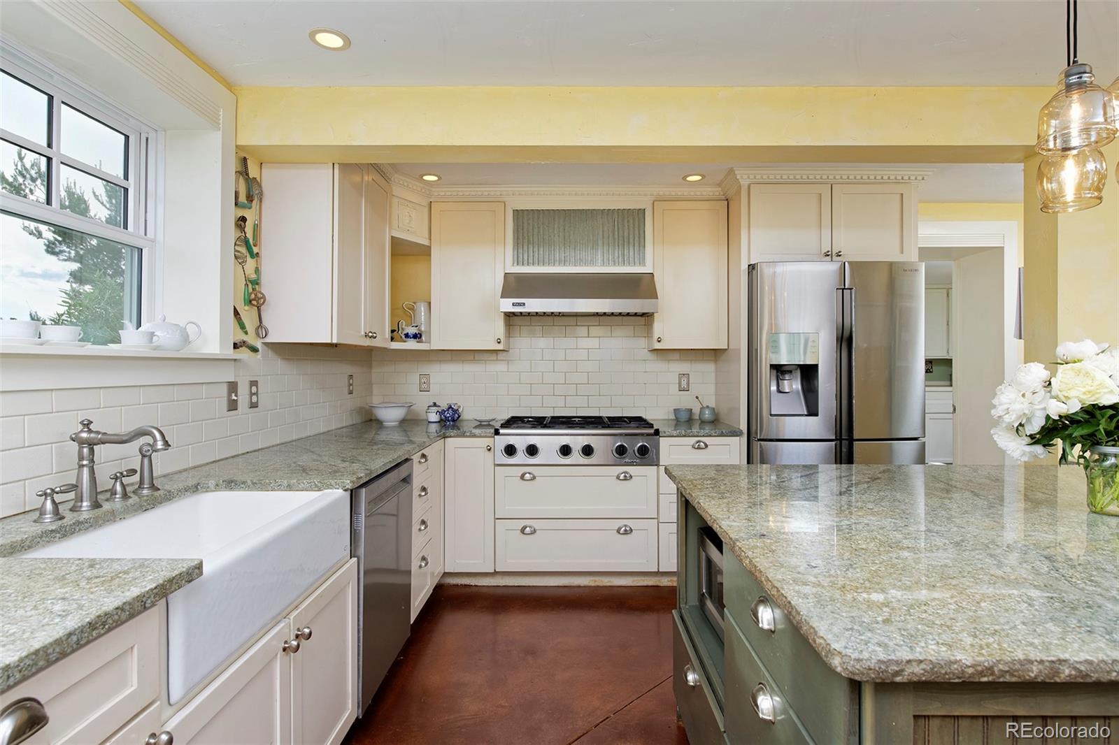 5875 Monarch Road Longmont, CO 80503 - Photo 14 of 38 a kitchen with a sink stove and refrigerator