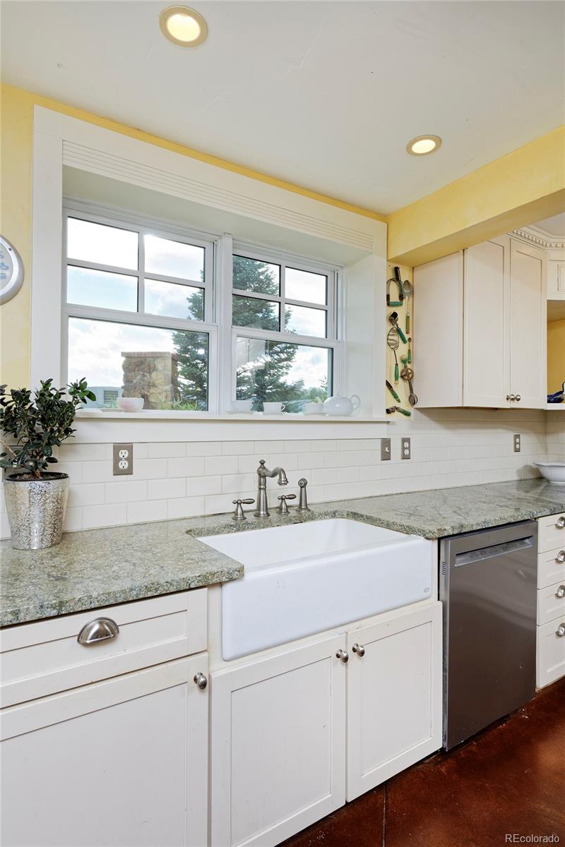 5875 Monarch Road Longmont, CO 80503 - Photo 15 of 38 a kitchen with stainless steel appliances white cabinets and a window