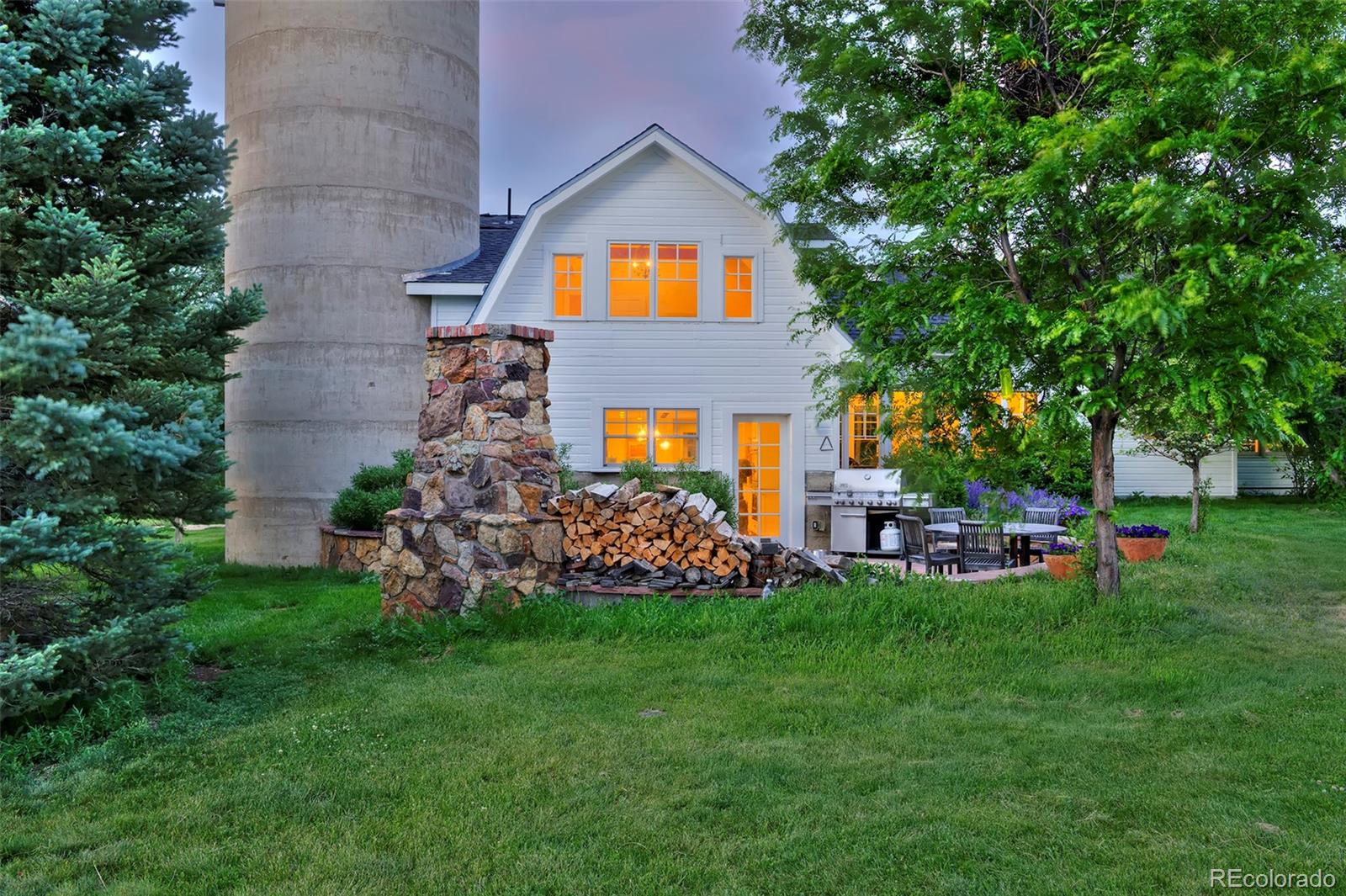 5875 Monarch Road Longmont, CO 80503 - Photo 2 of 38 a house with a big yard and potted plants in front of house