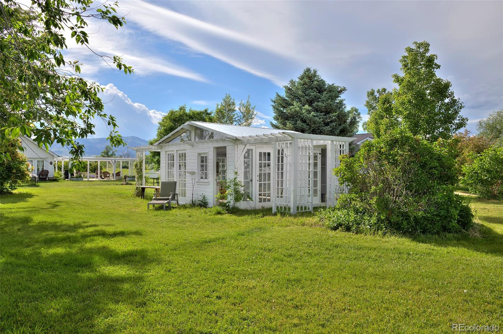 5875 Monarch Road Longmont, CO 80503 - Photo 37 of 38 a view of a house with a big yard and large trees