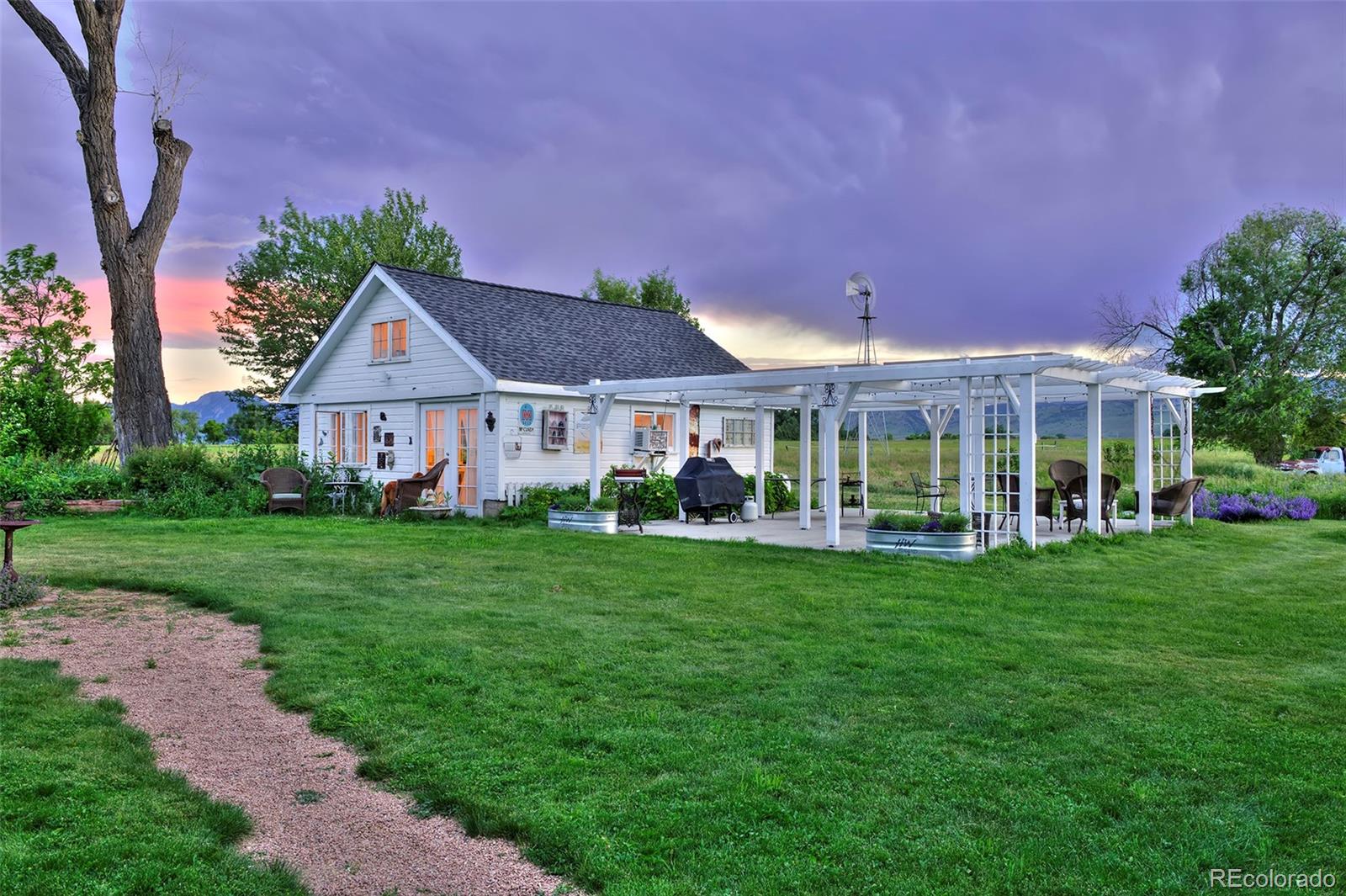 5875 Monarch Road Longmont, CO 80503 - Photo 7 of 38 a front view of a house with a yard table and chairs