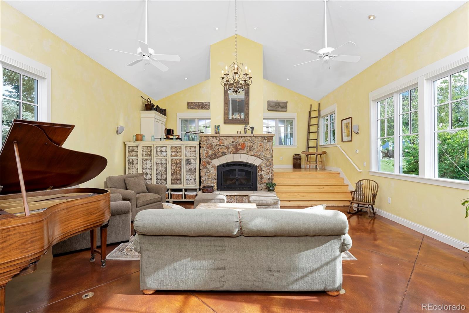5875 Monarch Road Longmont, CO 80503 - Photo 8 of 38 a living room with furniture a fireplace and a chandelier