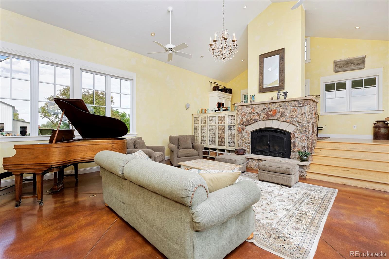 5875 Monarch Road Longmont, CO 80503 - Photo 9 of 38 a living room with furniture a fireplace and a table