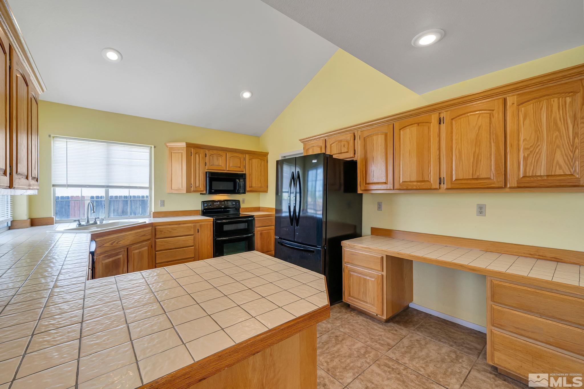 610 Sunset Drive Fallon, NV 89406 - Photo 13 of 36 a kitchen with stainless steel appliances a refrigerator sink and microwave