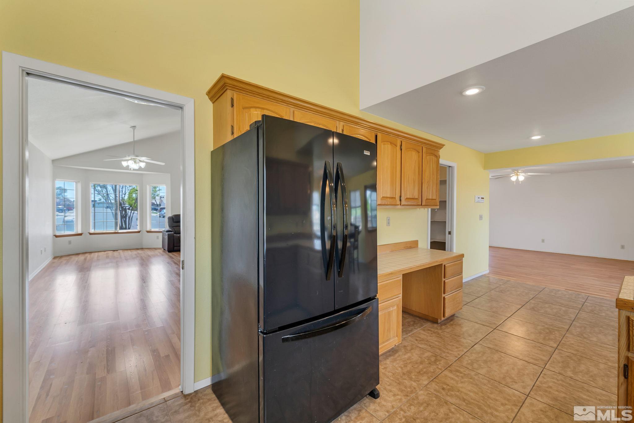 610 Sunset Drive Fallon, NV 89406 - Photo 16 of 36 a kitchen with stainless steel appliances granite countertop a refrigerator and a sink