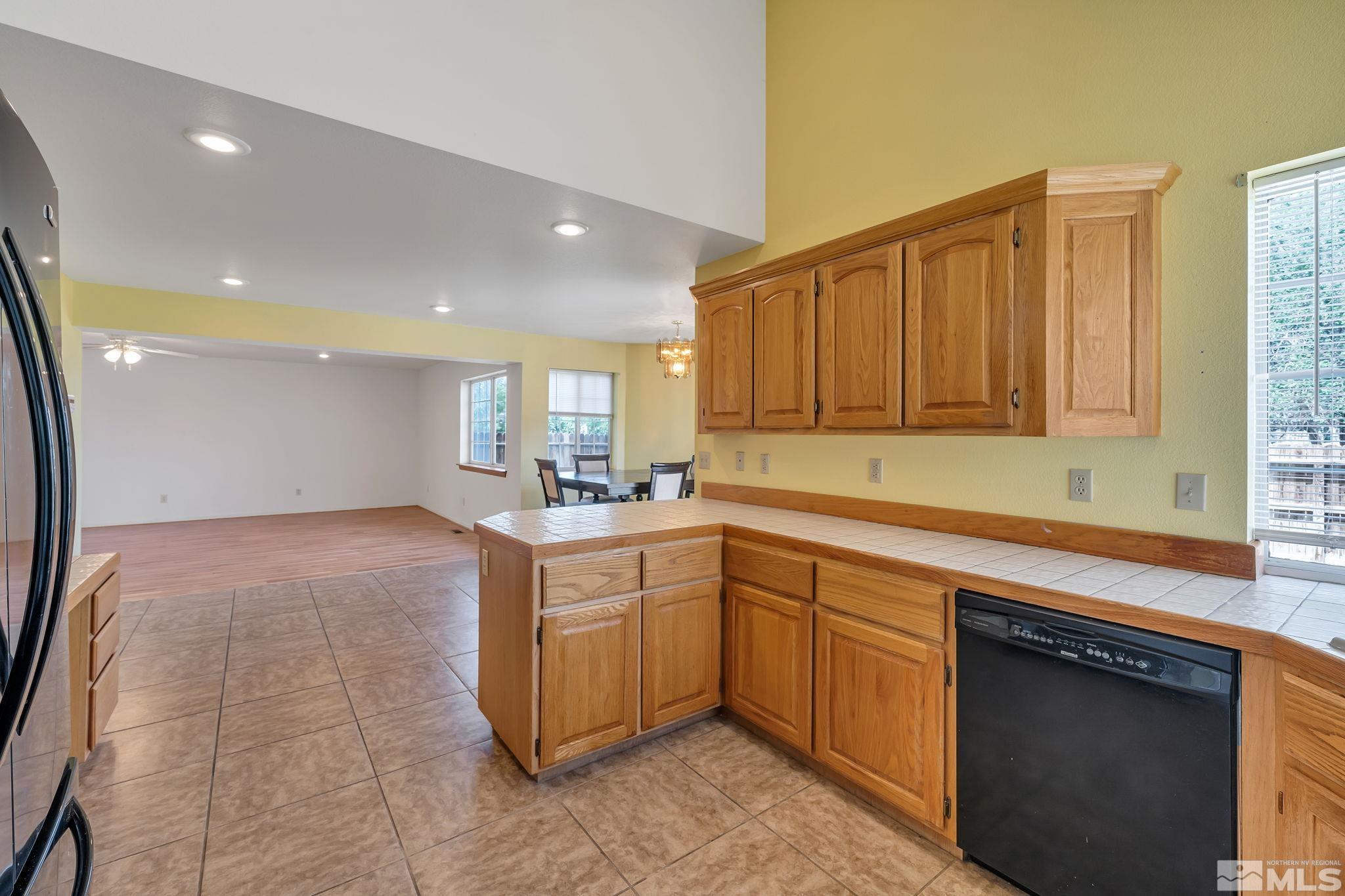 610 Sunset Drive Fallon, NV 89406 - Photo 17 of 36 a kitchen with stainless steel appliances granite countertop a stove a sink and a microwave