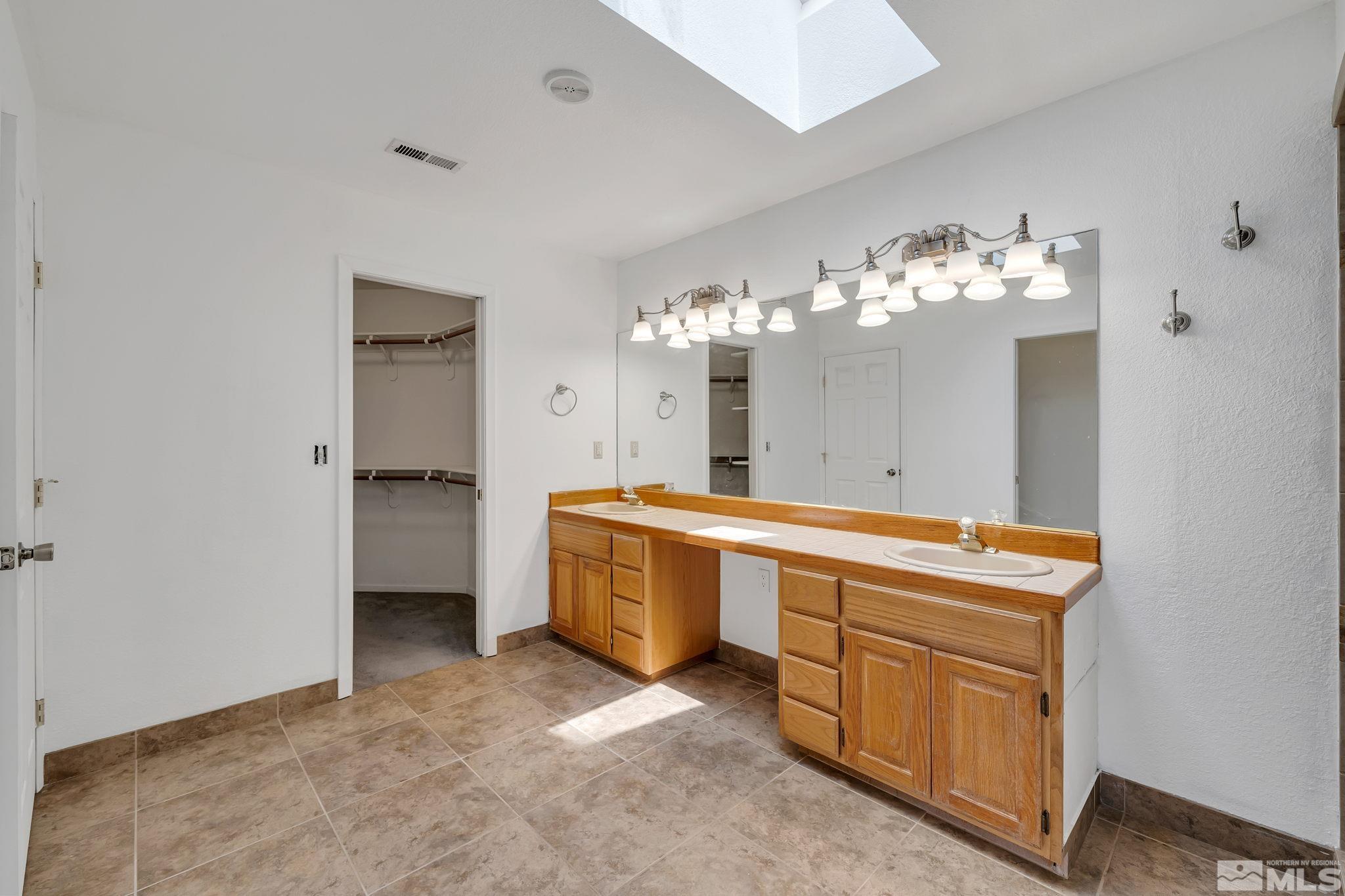 610 Sunset Drive Fallon, NV 89406 - Photo 24 of 36 a large bathroom with a sink and a large mirror