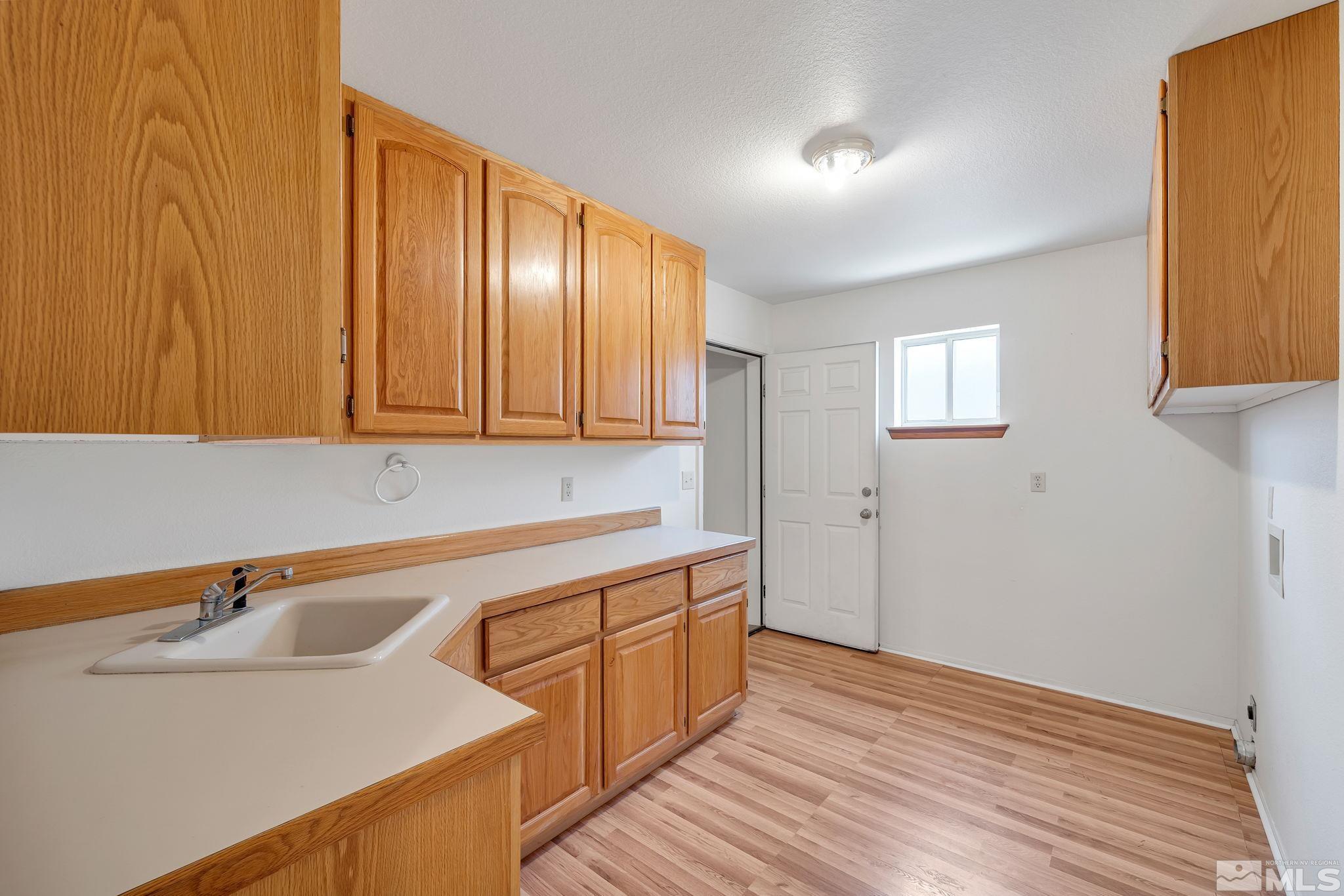 610 Sunset Drive Fallon, NV 89406 - Photo 27 of 36 a view of a kitchen with wooden floor and electronic appliances