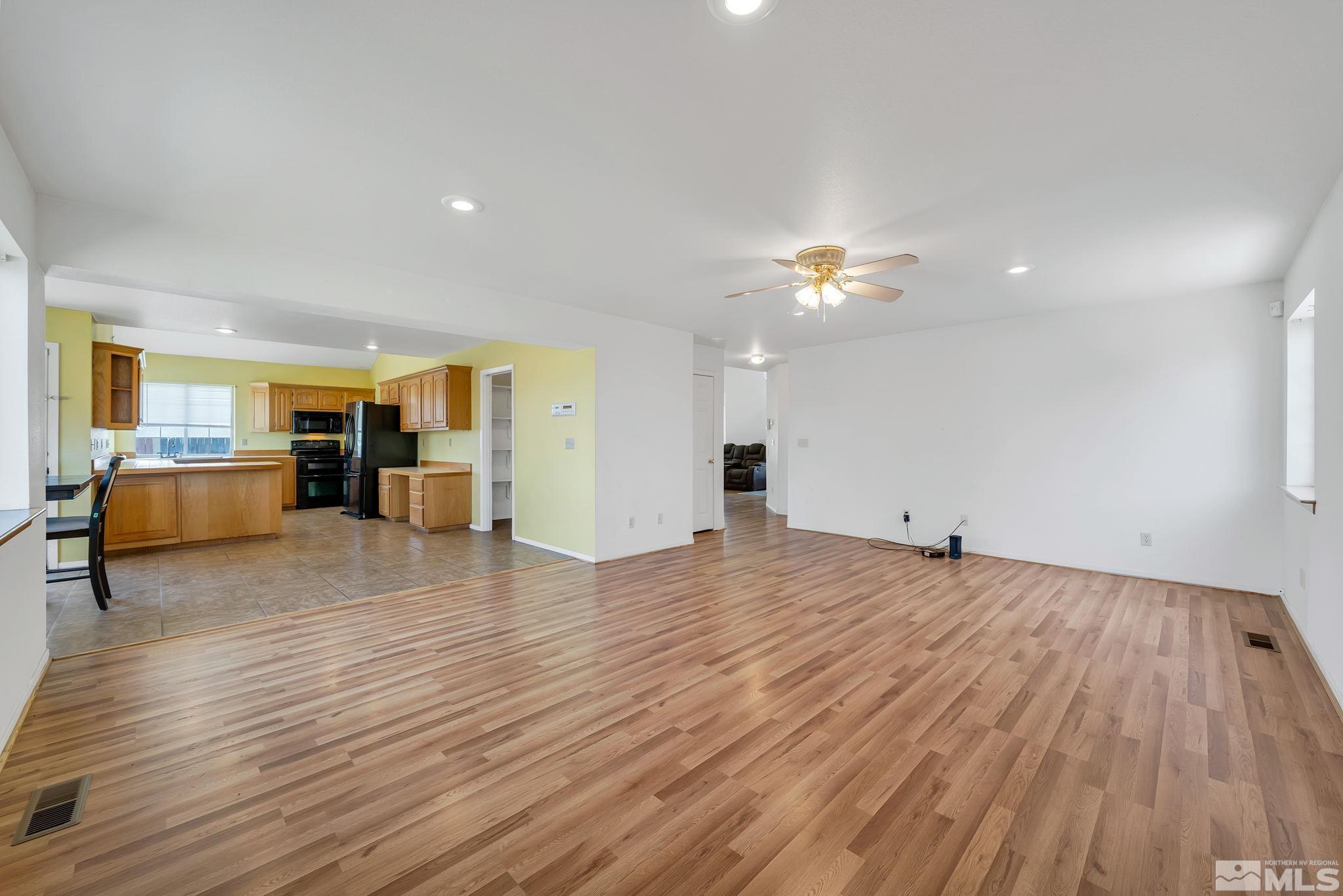610 Sunset Drive Fallon, NV 89406 - Photo 9 of 36 a view of a livingroom with a furniture hardwood floor and a ceiling fan