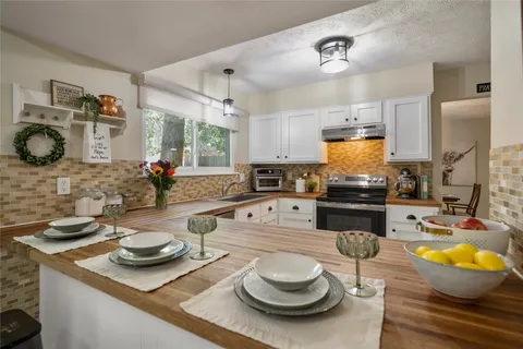 a kitchen with sink and stove