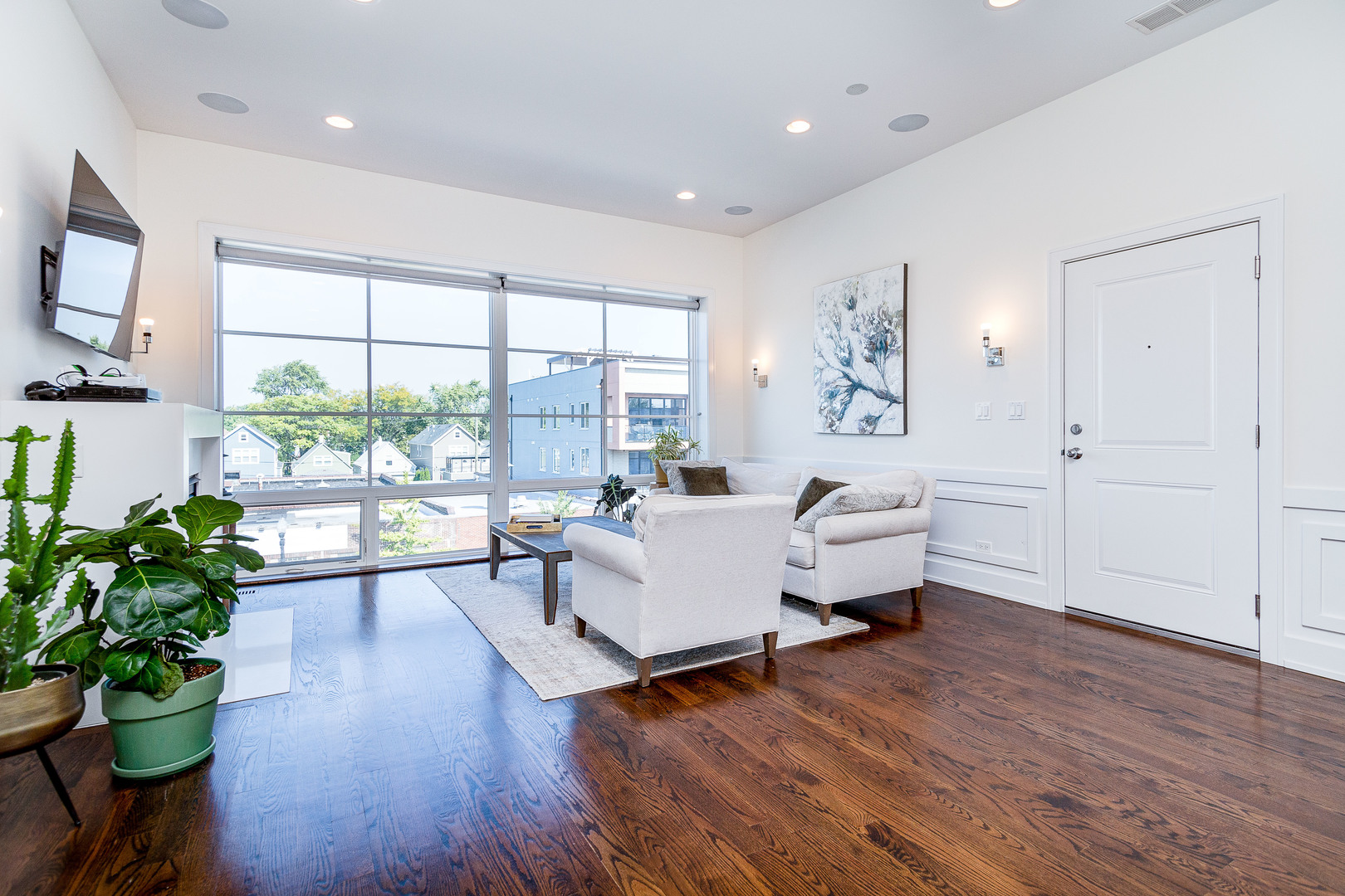 2453 West Irving Park Road, Unit 3W Chicago, IL 60618 - Photo 2 of 15 a living room with furniture and a large window with wooden floor