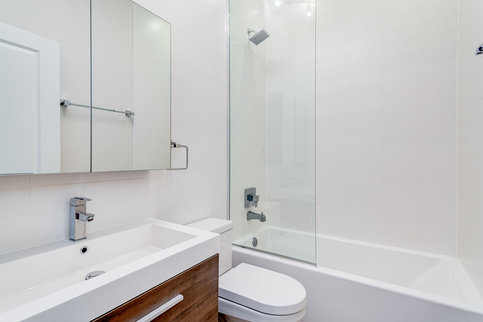 2453 West Irving Park Road, Unit 3W Chicago, IL 60618 - Photo 12 of 15 a bathroom with a sink a toilet and bathtub