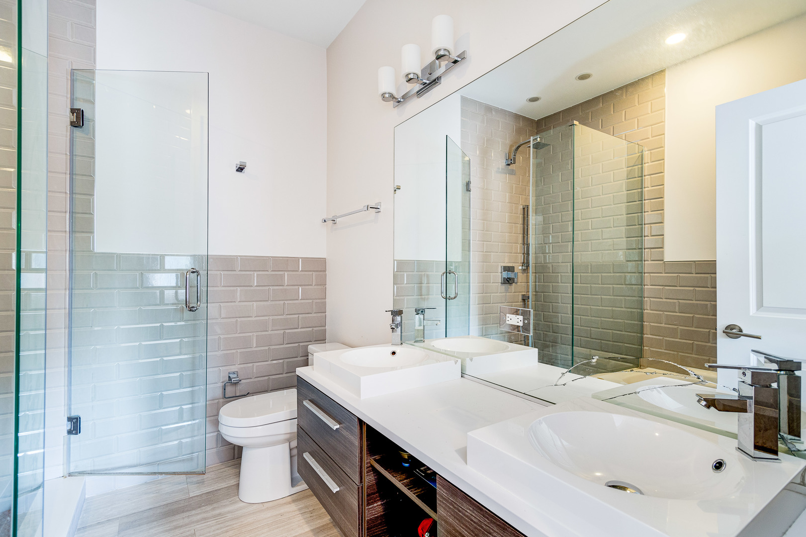 2453 West Irving Park Road, Unit 3W Chicago, IL 60618 - Photo 8 of 15 a bathroom with a sink double vanity and a toilet