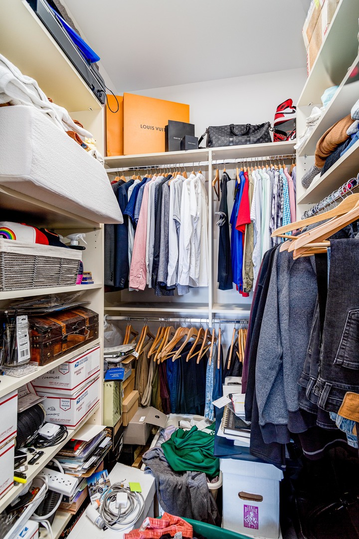 2453 West Irving Park Road, Unit 3W Chicago, IL 60618 - Photo 10 of 15 a view of walk in closet with clothes and shoes