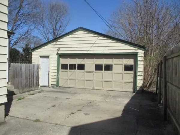 a view of a house with a wooden fence