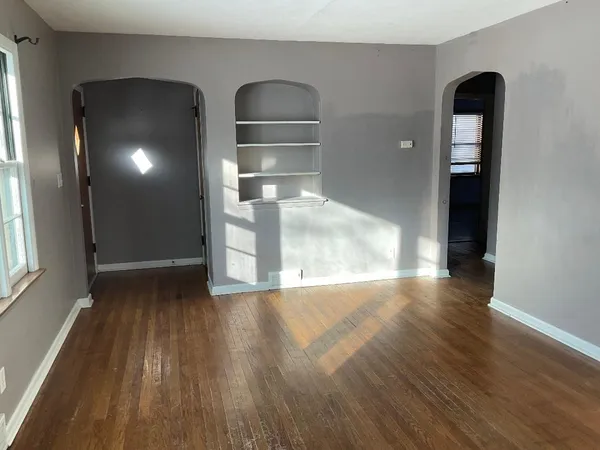 wooden floor in an empty room with a window