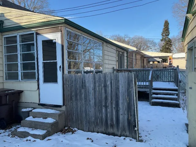 a view of a backyard with a chair and wooden floor