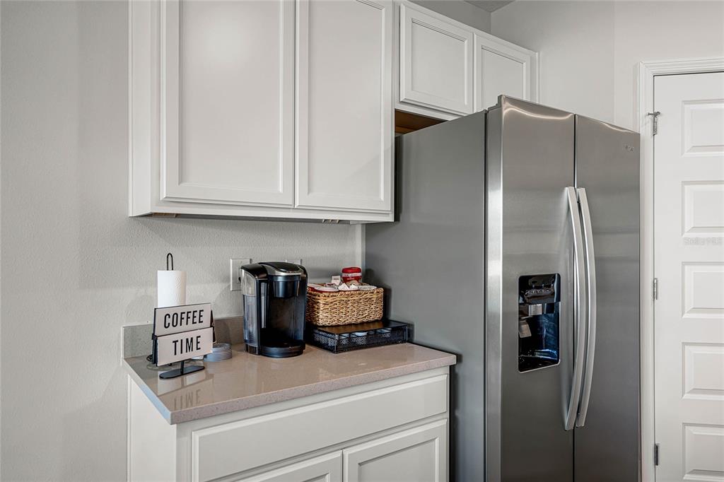 3514 Roden Road Haines City, FL 33844 - Photo 12 of 35 a kitchen with a refrigerator and cabinets
