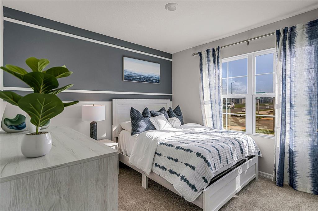 3514 Roden Road Haines City, FL 33844 - Photo 26 of 35 a bedroom with a bed and a potted plant