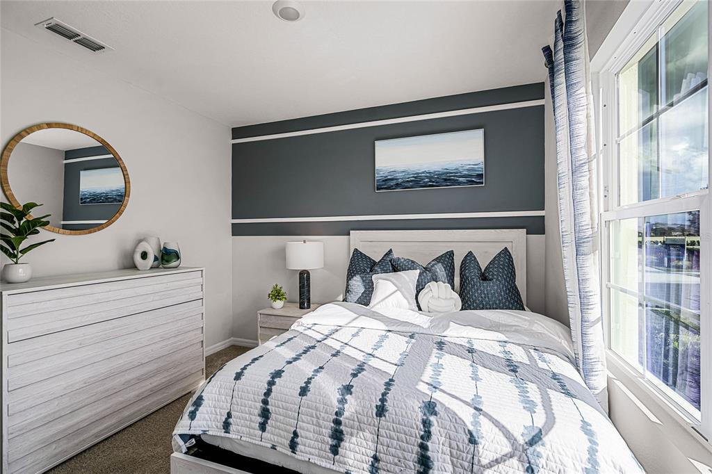 3514 Roden Road Haines City, FL 33844 - Photo 29 of 35 a bedroom with a bed and a mirror