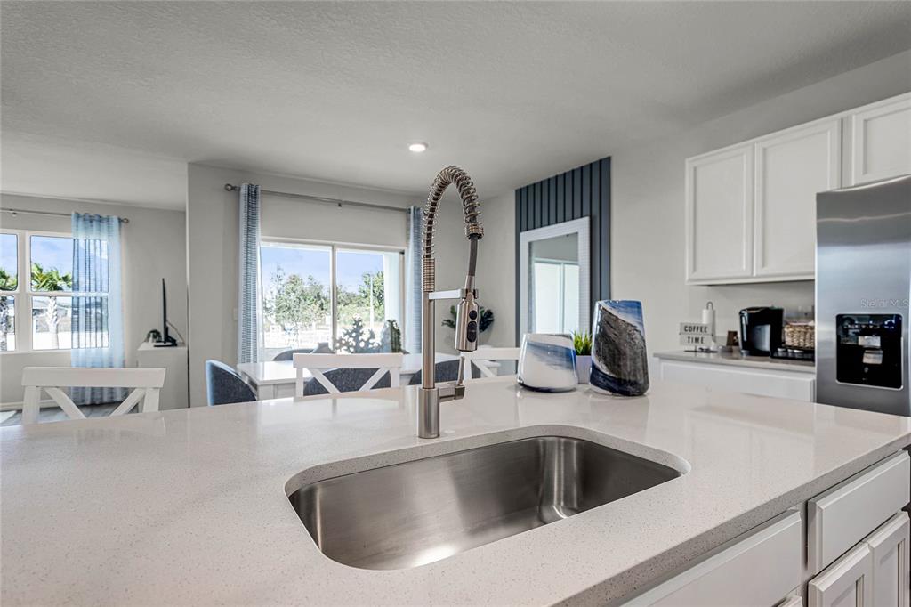 3514 Roden Road Haines City, FL 33844 - Photo 10 of 35 a kitchen with sink refrigerator and cabinets