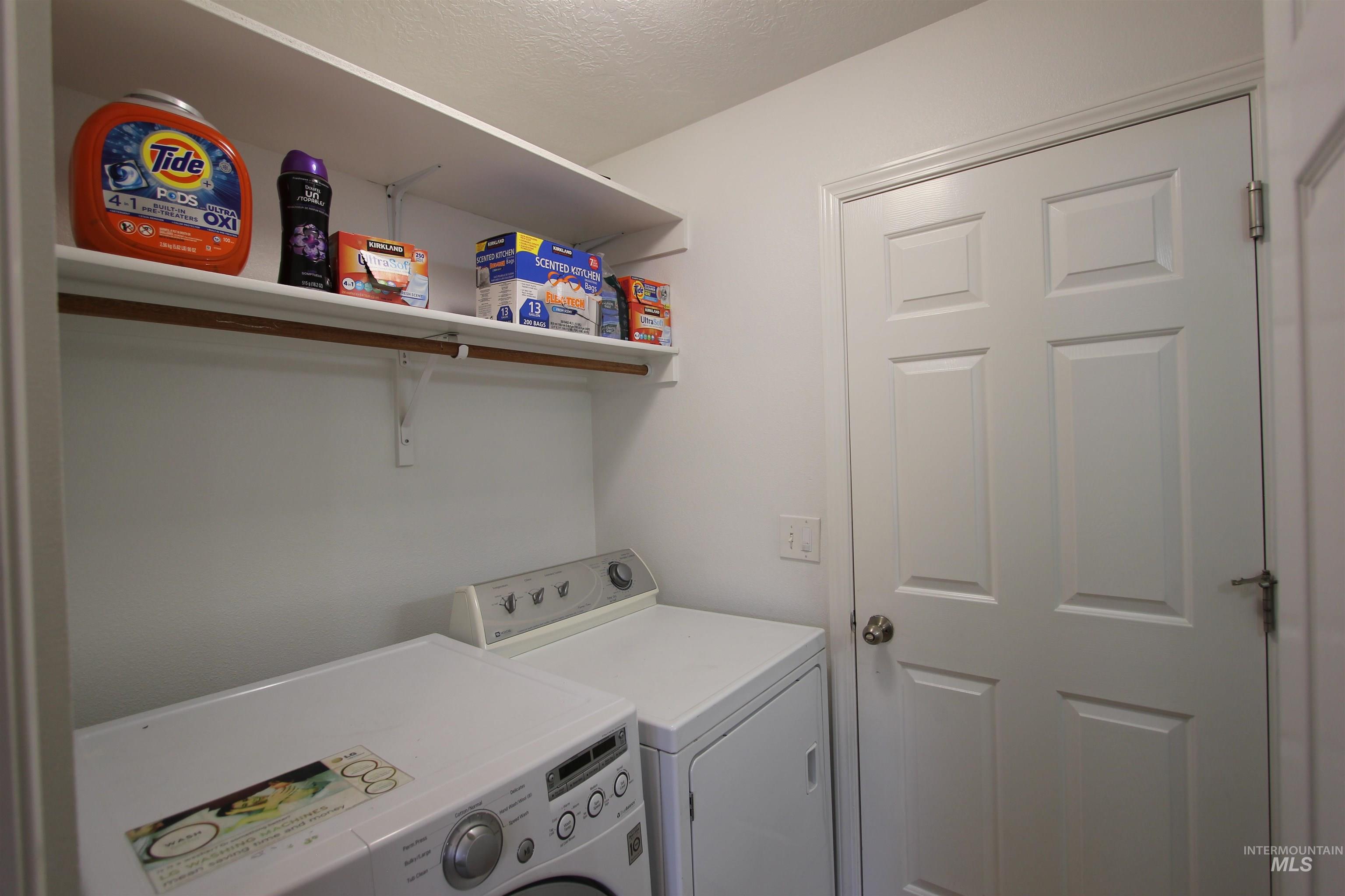 4816 Kadie Street Caldwell, ID 83607 - Photo 13 of 23 Laundry area featuring white walls, overhead shelving, and a six-panel interior door with a chrome knob