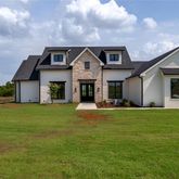 a front view of house with yard and green space