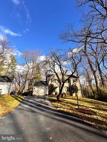 a view of a yard with yellow house