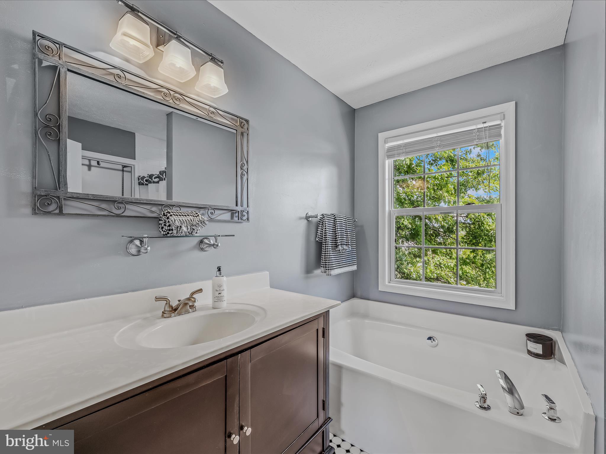 571 Oak Lee Drive Ranson, WV 25438 - Photo 12 of 45 a bathroom with a tub sink and mirror