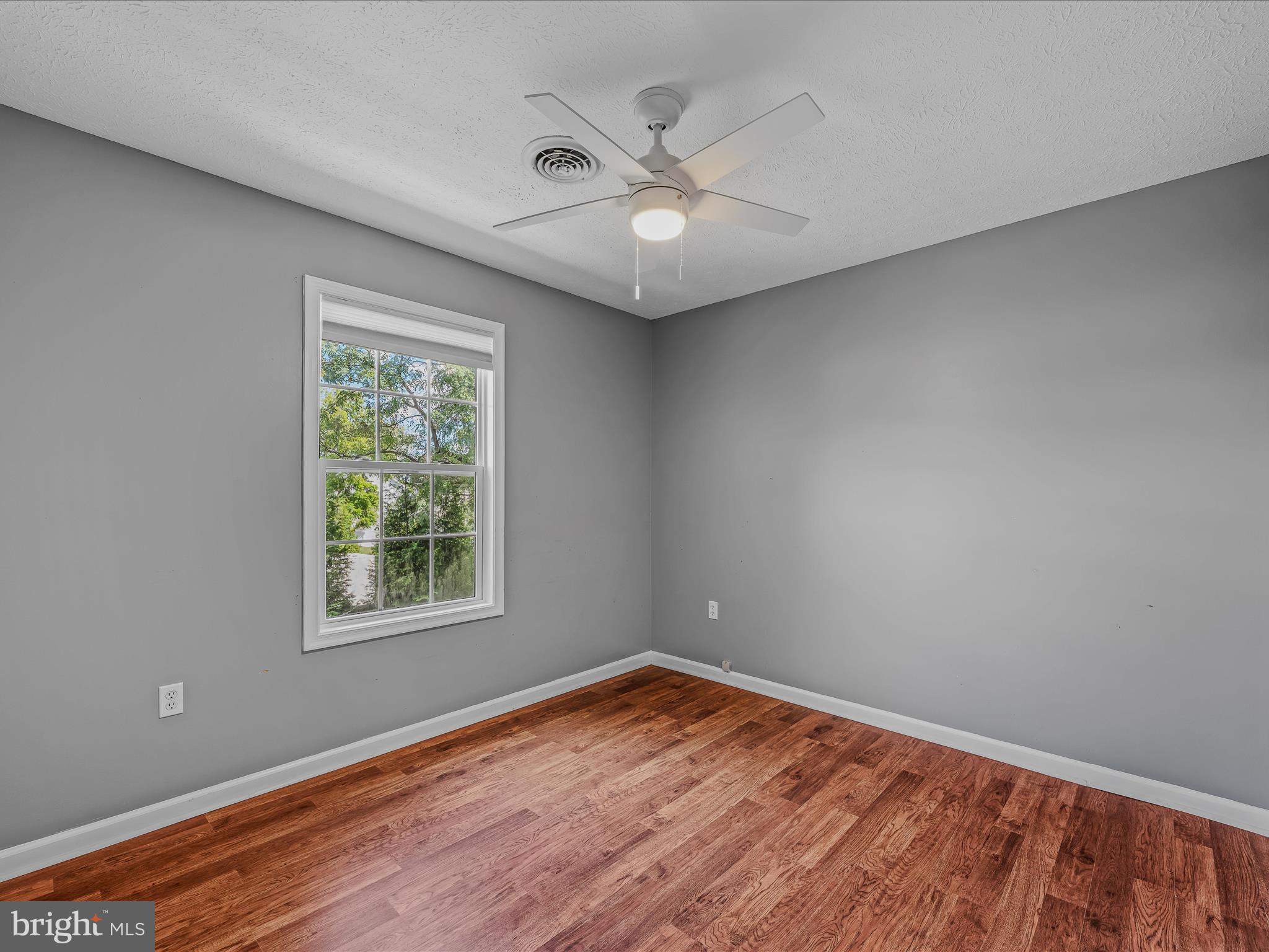 571 Oak Lee Drive Ranson, WV 25438 - Photo 15 of 45 an empty room with wooden floor and windows