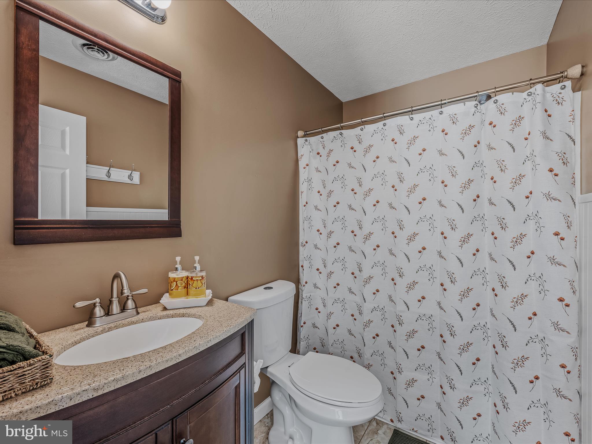 571 Oak Lee Drive Ranson, WV 25438 - Photo 17 of 45 a bathroom with a granite countertop sink mirror vanity and toilet