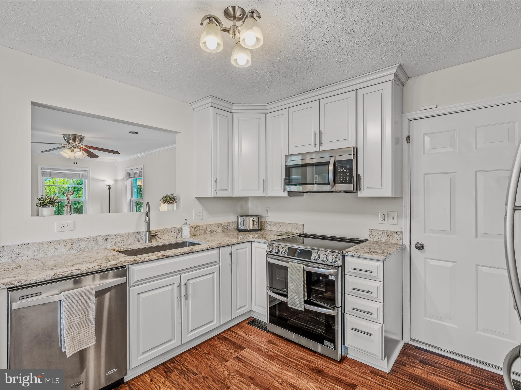 571 Oak Lee Drive Ranson, WV 25438 - Photo 5 of 45 a kitchen with stainless steel appliances granite countertop a stove and a sink