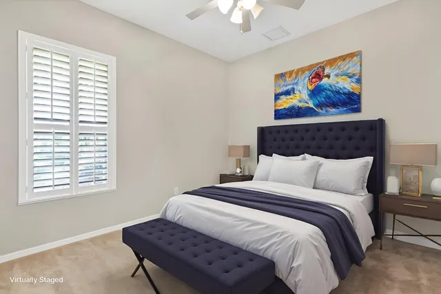 a bedroom with a bed and a painting on the wall