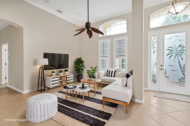 a living room with furniture a flat screen tv and a window