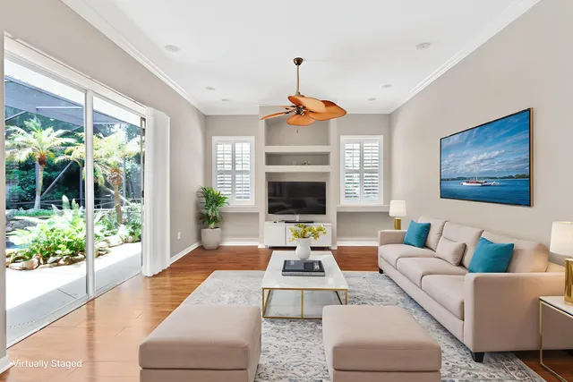 a living room with furniture fireplace and a large window