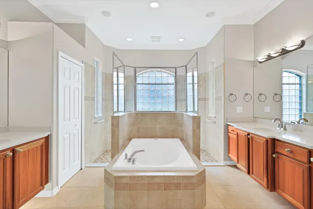 a bathroom with a sink a large mirror and a bathtub